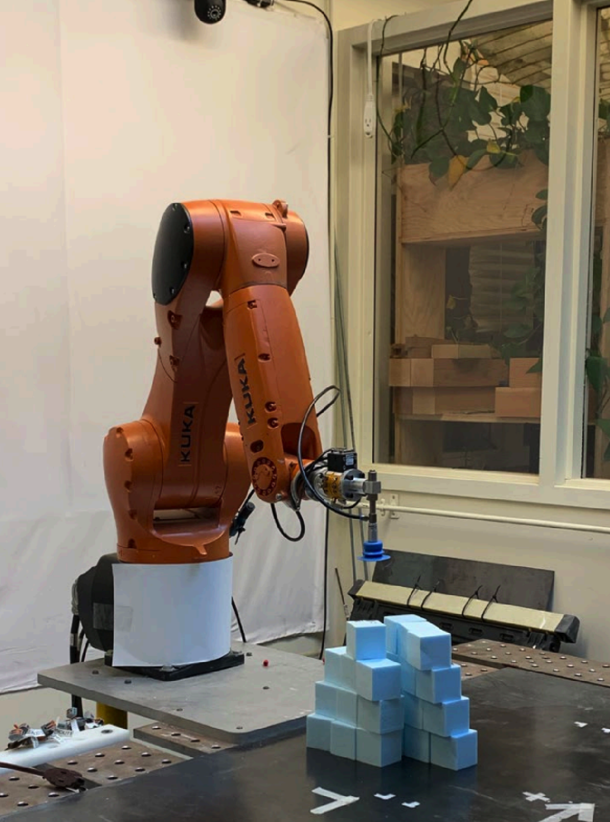 KUKA robotic arm assembling the foam-cube structure